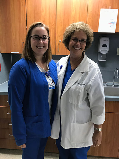 Couple of nursing professionals standing together for photo